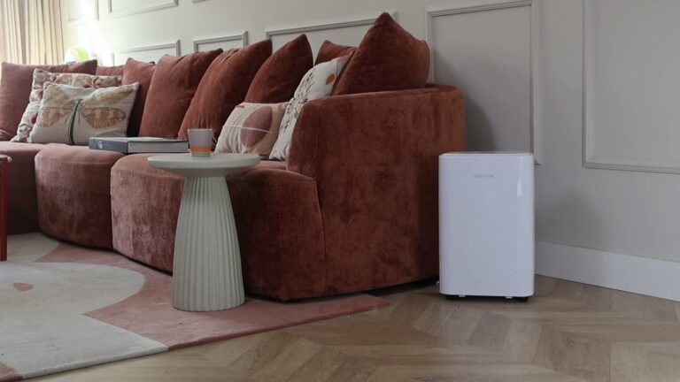 Witte Helthome Smart Air 20L luchtontvochtiger naast een roestbruine bank in de woonkamer