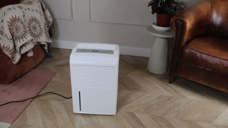 Trotec TTK 90 E luchtontvochtiger naast een leren fauteuil in de woonkamer